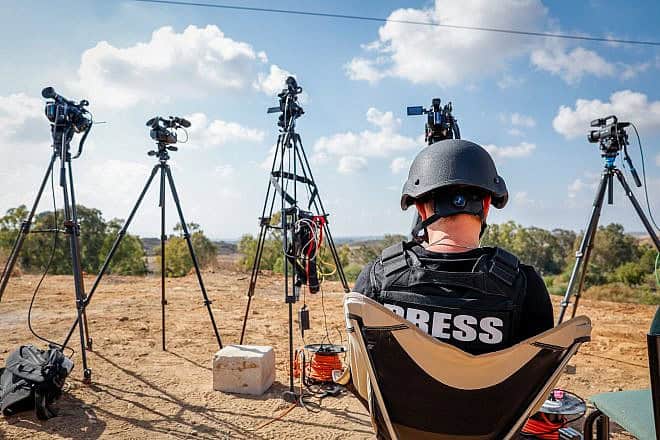 Journalists on a hill overlooking the Gaza Strip in the town of Sderot in southern Israel, Oct. 19, 2023. Photo by Nati Shohat/Flash90.