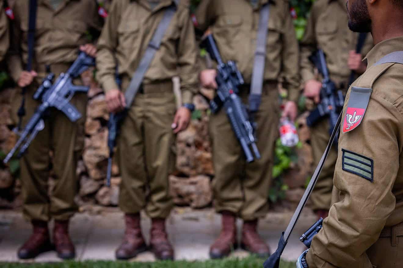 Israeli soldiers from the Netzah Yehuda Battalion visit graves of fallen Israeli soldiers at Mount Herzl Military Cemetery in Jerusalem, on May 12, 2024, ahead of Israeli Memorial Day, which began on Sunday night, May 12, 2024. Photo by Chaim Goldberg/Flash90.
