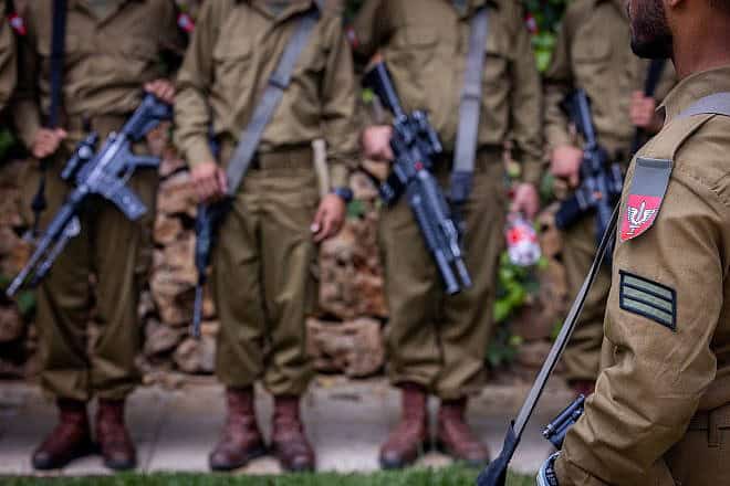 Israeli soldiers from the Netzah Yehuda Battalion visit graves of fallen Israeli soldiers at Mount Herzl Military Cemetery in Jerusalem, on May 12, 2024, ahead of Israeli Memorial Day, which began on Sunday night, May 12, 2024. Photo by Chaim Goldberg/Flash90.