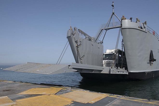Aid trucks driving onto the U.S.-built temporary floating pier off the Gaza coast, May 17, 2024. Credit: U.S. Central Command.