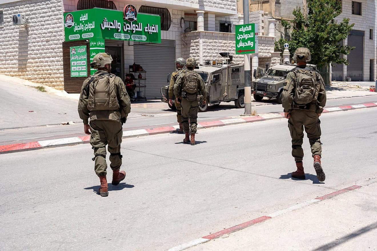 Israeli troops arrest a Palestinian terrorist in Awarta, near Nablus (Shechem) in central Samaria, May 16, 2024. Credit: IDF.