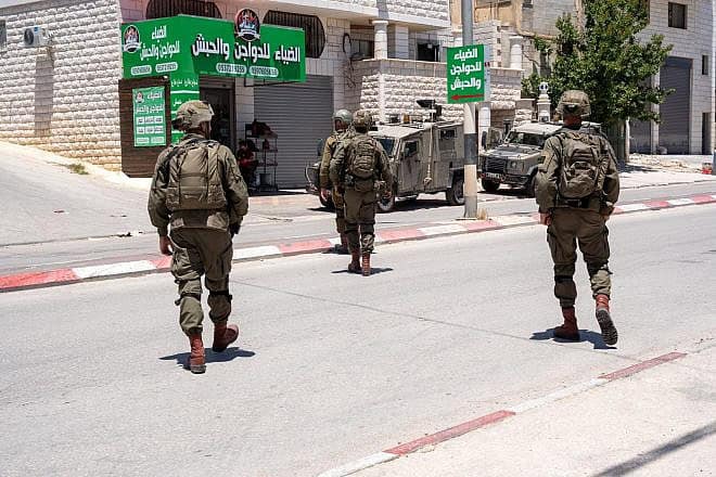 Israeli troops arrest a Palestinian terrorist in Awarta, near Nablus (Shechem) in central Samaria, May 16, 2024. Credit: IDF.
