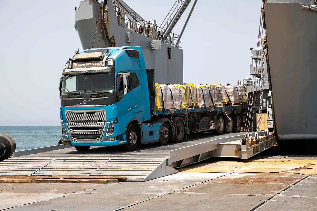 A humanitarian-aid truck rolls off the U.S.-built floating pier on its journey to a U.N. warehouse in Gaza. Source: CENTCOM/X.
