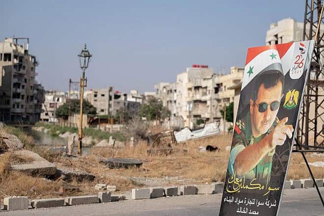 A poster of President Bashar Assad in Homs's destroyed city center during the Syrian civil war, Aug. 25, 2021. Photo by Lena Ha/Shutterstock.
