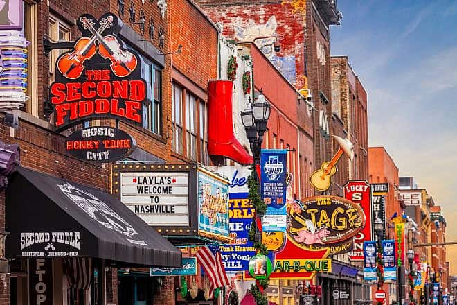 Famous neon signs of blues clubs on Beale street in downtown Nashville, where the American Jewish Press Association will celebrate its 80th-year milestone. Credit: Photo Spirit/Shutterstock.