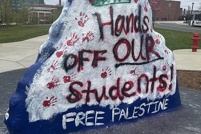 A rock at the University of Connecticut painted with pro-Palestinian, anti-Israel messages in response to the arrest of student protesters at the school earlier in the day, April 30, 2024. Credit: RosaSeaOtter via Wikimedia Commons.