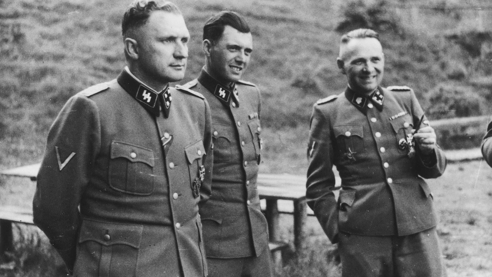 From left: German Nazi officers Richard Baer, Josef Mengele and Rudolf Höss on the grounds of the SS retreat outside of the Auschwitz concentration camp in Poland in 1944. Credit: United States Holocaust Memorial Museum via Wikimedia Commons.