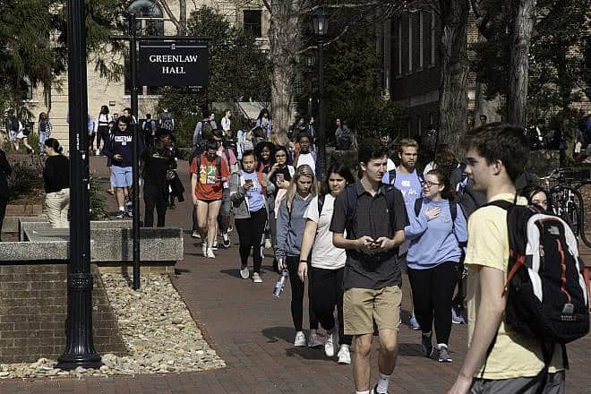 Students at the University of North Carolina at Chapel Hill walk through campus between classes on Feb. 6, 2019. Photo by Dennis Ludlow-Sharkshock via Wikimedia Commons.