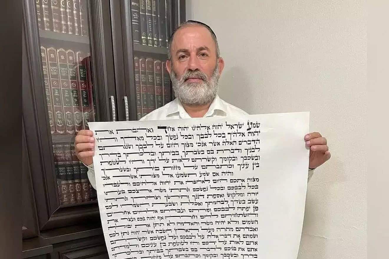 Rabbi Meir Peretz with the mezuzah scroll. Credit: Courtesy.