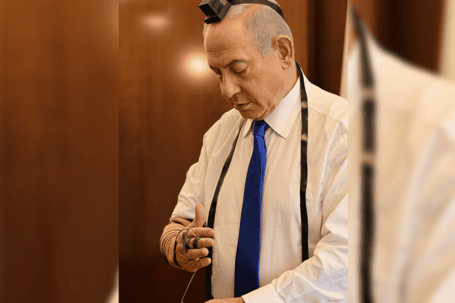Israeli Prime Minister Benjamin Netanyahu dons tefillin (phylacteries), May 12, 2024. Credit: Prime Minister's Office.