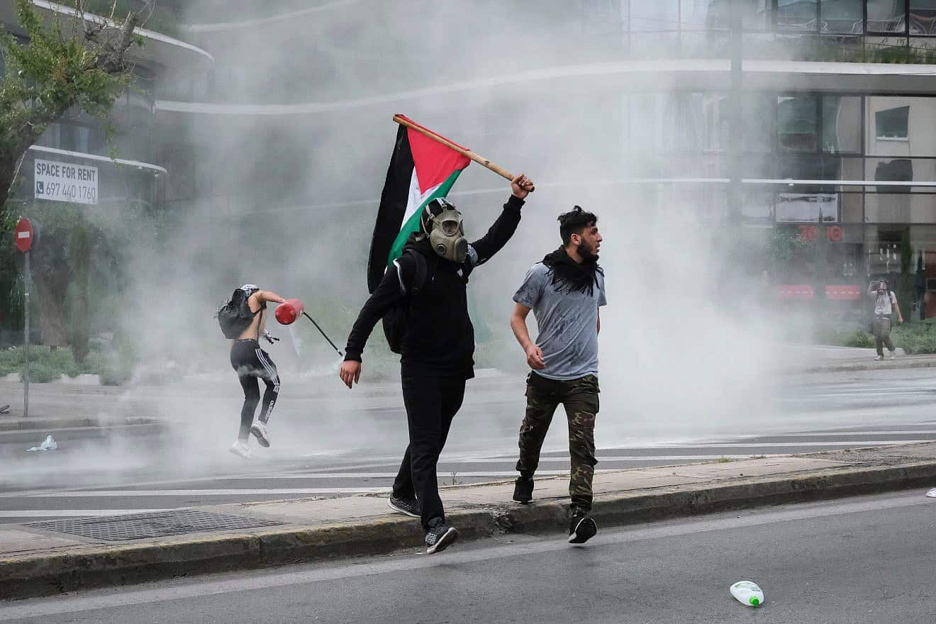 Riot police use pepper spray and a water cannon against pro-Palestinian protesters outside the Israeli embassy in Athens, Greece, on May 15, 2021. Credit: Alexandros Michailidis/Shutterstock.