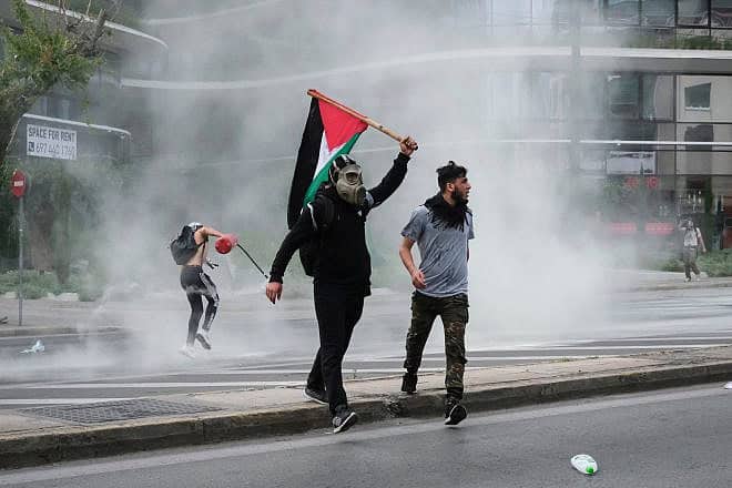 Riot police use pepper spray and a water cannon against pro-Palestinian protesters outside the Israeli embassy in Athens, Greece, on May 15, 2021. Credit: Alexandros Michailidis/Shutterstock.