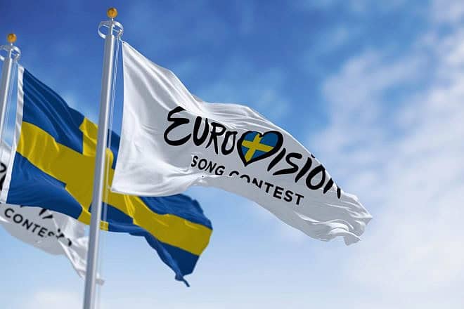 Sweden's national flag alongside a Eurovision Song Contest banner in Malmo, Sweden, Oct. 25, 2023. Credit: Rarrarorro/Shutterstock.