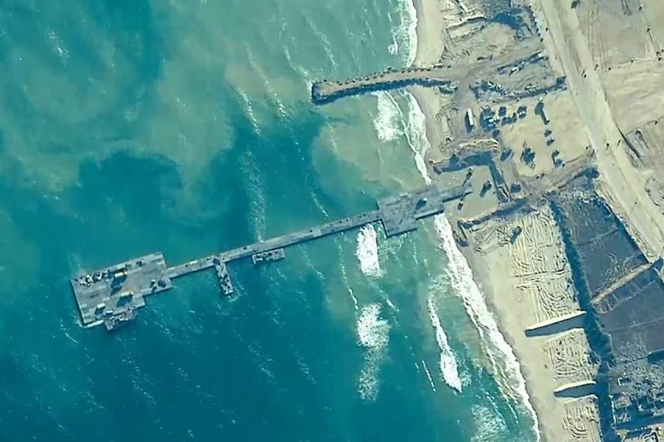U.S. Army soldiers assigned to the 7th Transportation Brigade (Expeditionary), U.S. Navy sailors assigned to Amphibious Construction Battalion 1, and IDF soldiers emplace the Trident Pier on the Gaza coast, May 16, 2024. Credit: Courtesy.