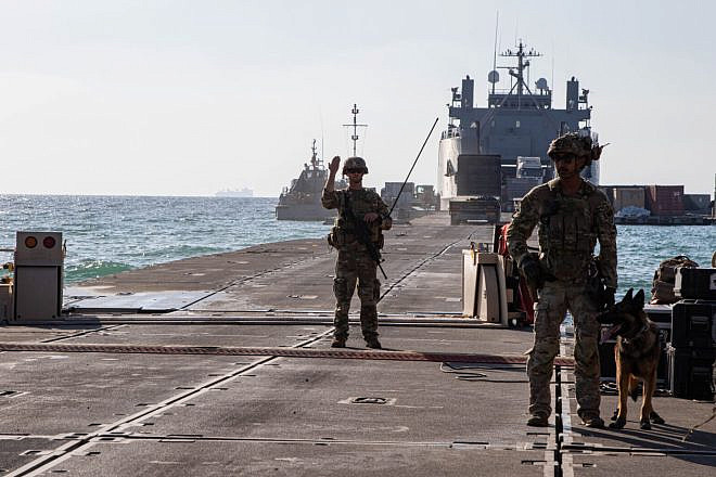 A U.S. Army central soldier directs traffic across the Trident Pier, and onto the U.S. Army vessel LSV-1, June 22, 2024. Credit: Staff Sgt. Malcolm Cohens-Ashley/U.S. Army photo.