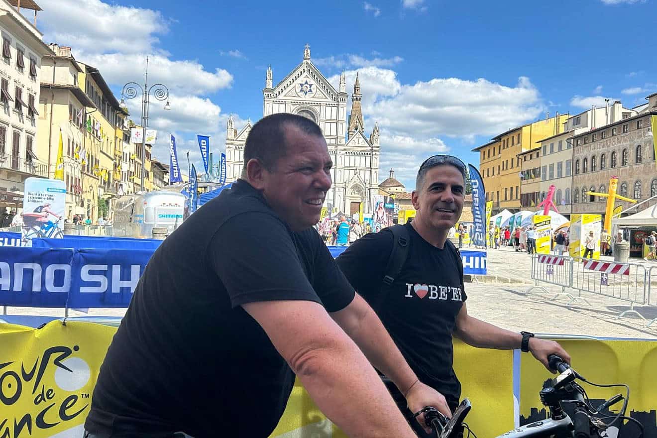 Oct. 6 survivors Avida Bachar (left) and Sharon Shevo finish their ride at the Tour de France fan zone in Piazza Santa Croce, Florence, June 27, 2024. Photo by Amelie Botbol.