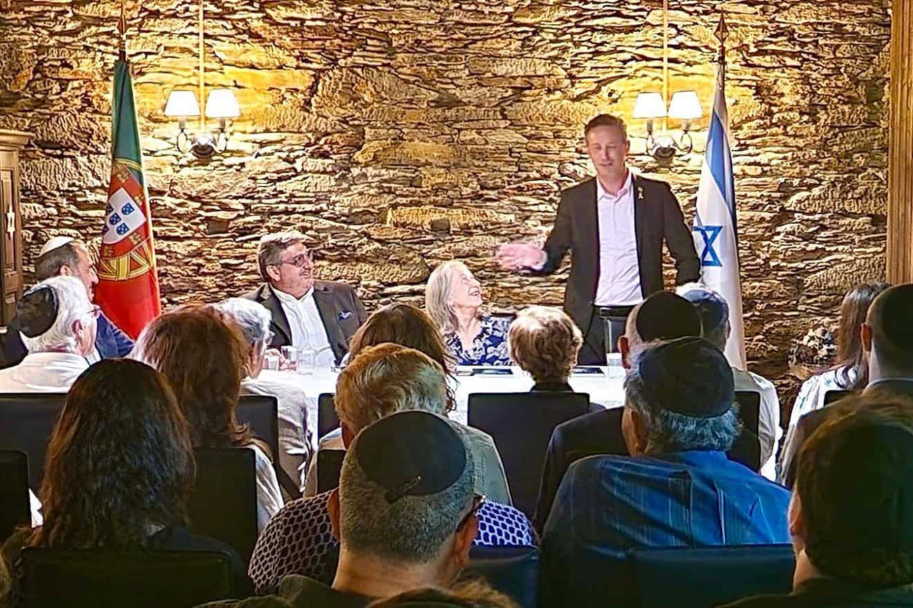 Israeli Ambassador to Portugal Dor Shapira addresses attendees at book release in Oporto, Portugal. Ambassador Manuela Franco (seated middle) and Dr. Luis Campos Ferreira (seated left) look on. Credit: Courtesy.
