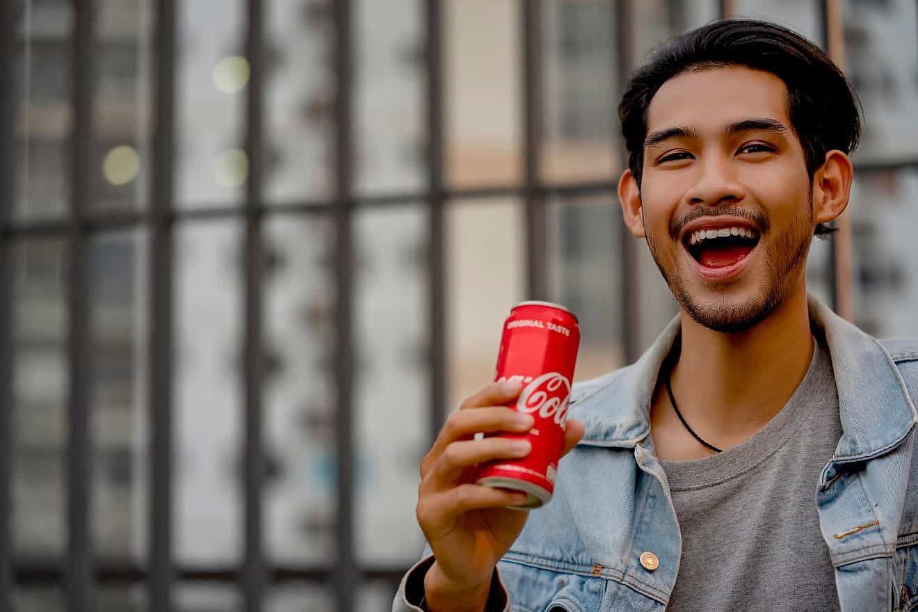 A man enjoys Coca-Cola in Bangkok, Feb. 2, 2020. Credit: 15Studio/Shutterstock.