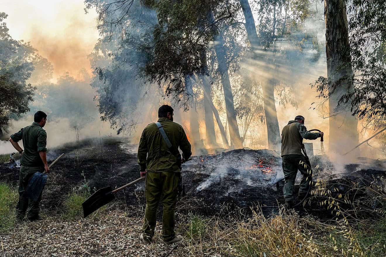 Members of an emergency squad try to extinguish a fire caused by rockets fired from Lebanon, near the northern Israeli town of Kiryat Shmona, June 4, 2024. Photo by Ayal Margolin/Flash90.