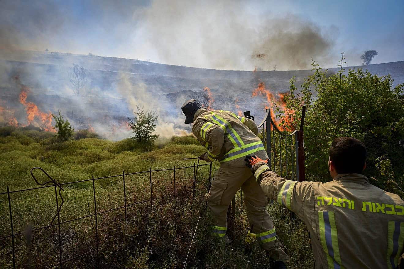 Israeli firefighters try to extinguish a fire sparked by missiles launched from Lebanon, near the northern city of Safed, June 12, 2024. Photo by Michael Giladi/Flash90.