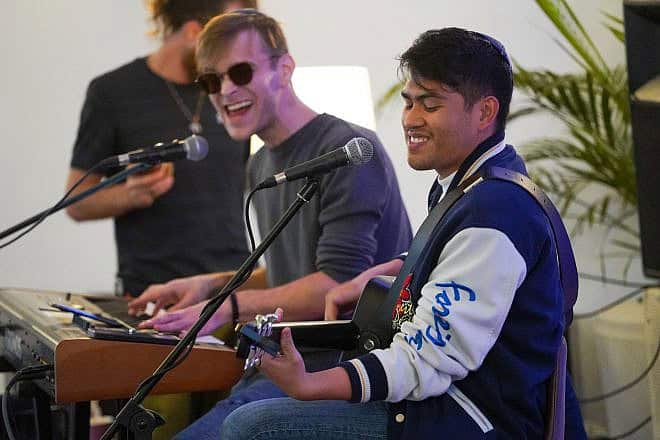 Filipino-Israeli singer Howie Danao on guitar. Credit: Courtesy.