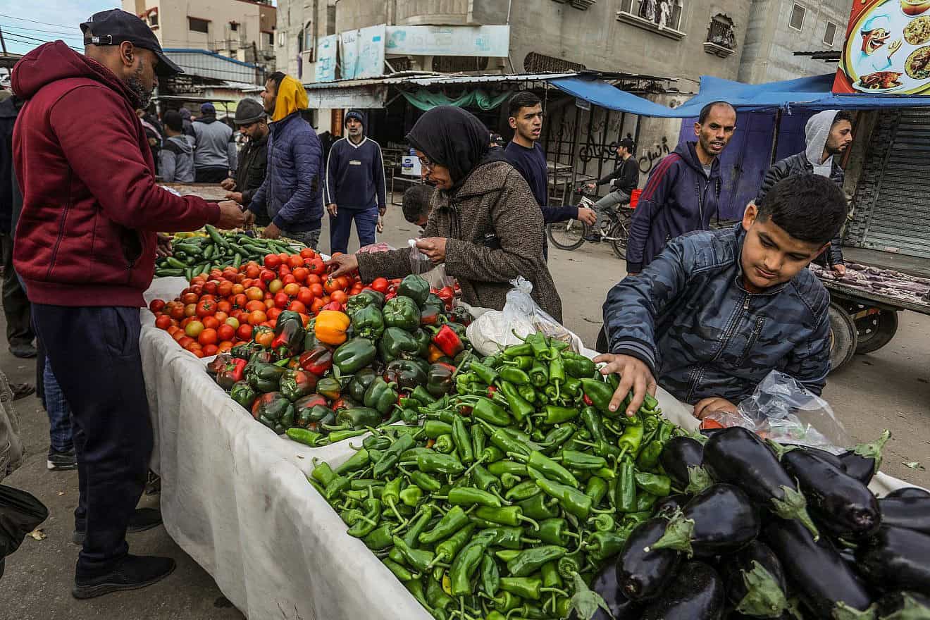 Palestinians shop for fruit and vegetables at a market in Rafah, in the southern Gaza Strip, on Jan. 13, 2024. Photo by Abed Rahim Khatib/Flash90.