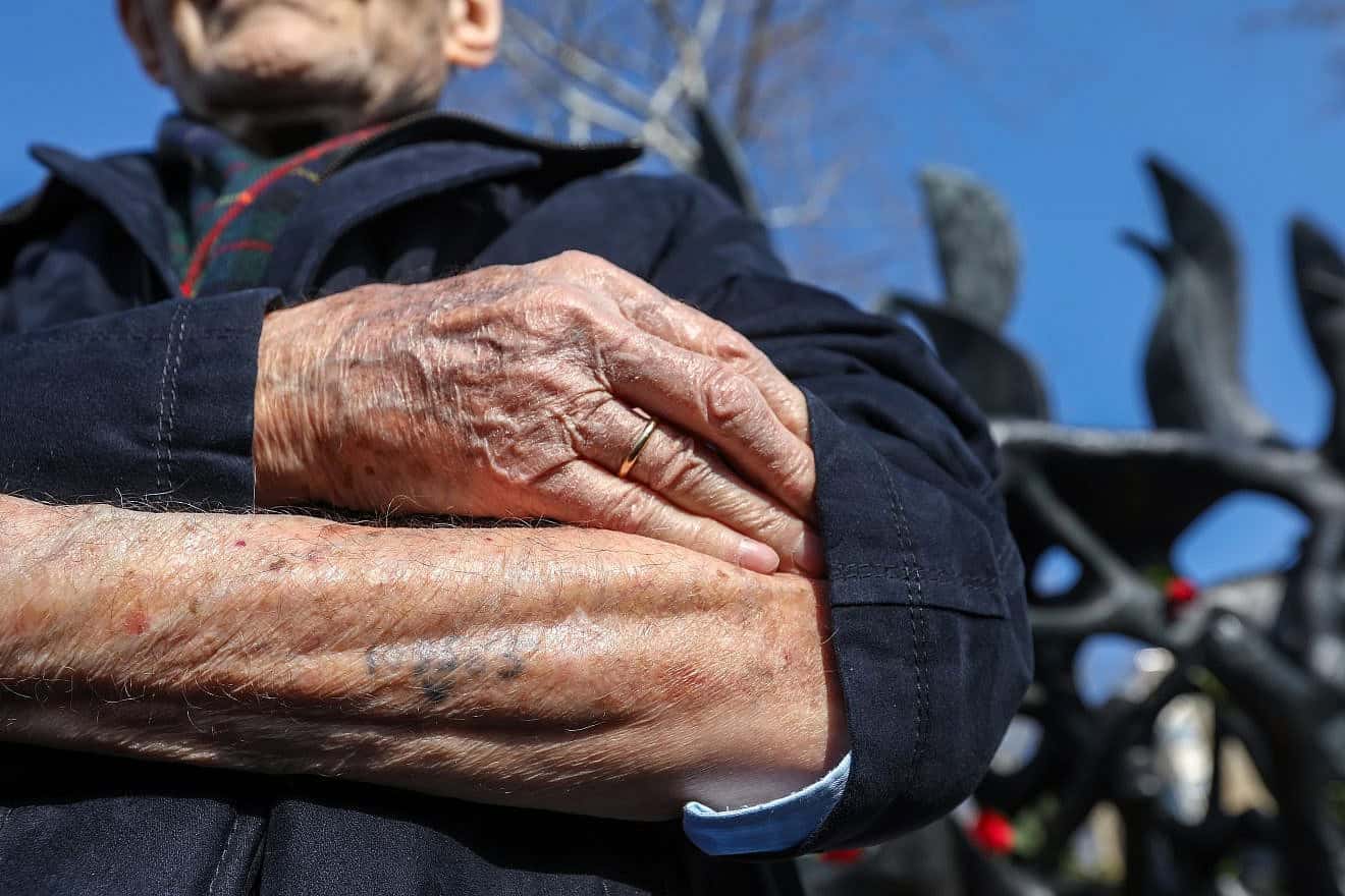 Holocaust survivor Heinz Kounio shows his serial number, tattooed by German Nazis, during a ceremony recalling the persecution of the Jewish people during World War II, in Thessaloniki, Greece Jan. 28, 2018. Credit: Ververidis Vasilis/Shutterstock.