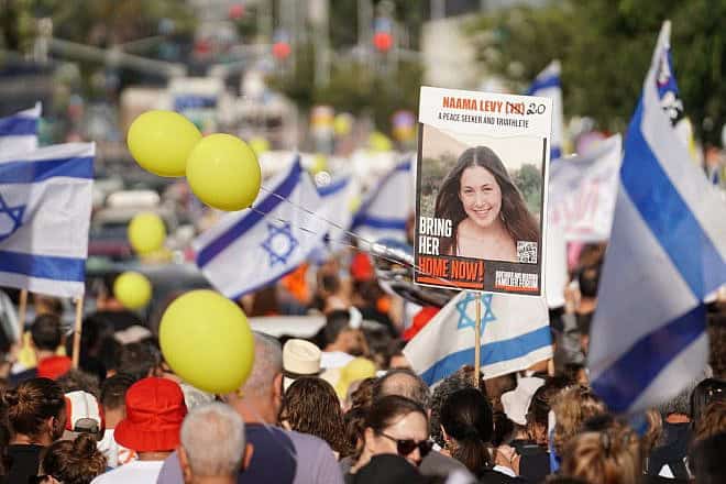 Captive Naama Levy appears on a poster at a rally at Kaplan Street in Tel Aviv calling to free the hostages held in Gaza, June 22, 2024. Photo by Lior Segev.