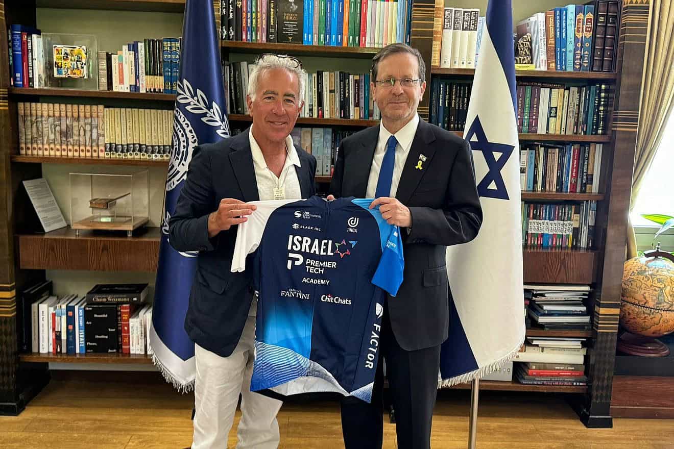 Israel-Premier Tech owner Sylvan Adams presents President Isaac Herzog with a team jersey at the President's Residence in Jerusalem, June 23, 2024. Credit: Courtesy.