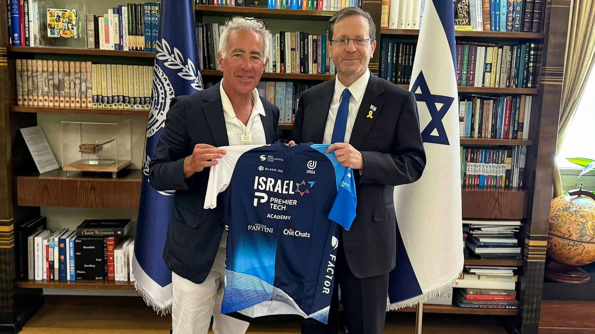 Israel-Premier Tech owner Sylvan Adams presents President Isaac Herzog with a team jersey at the President's Residence in Jerusalem, June 23, 2024. Credit: Courtesy.