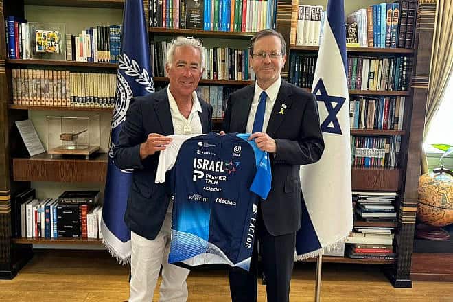 Israel-Premier Tech owner Sylvan Adams presents President Isaac Herzog with a team jersey at the President's Residence in Jerusalem, June 23, 2024. Credit: Courtesy.