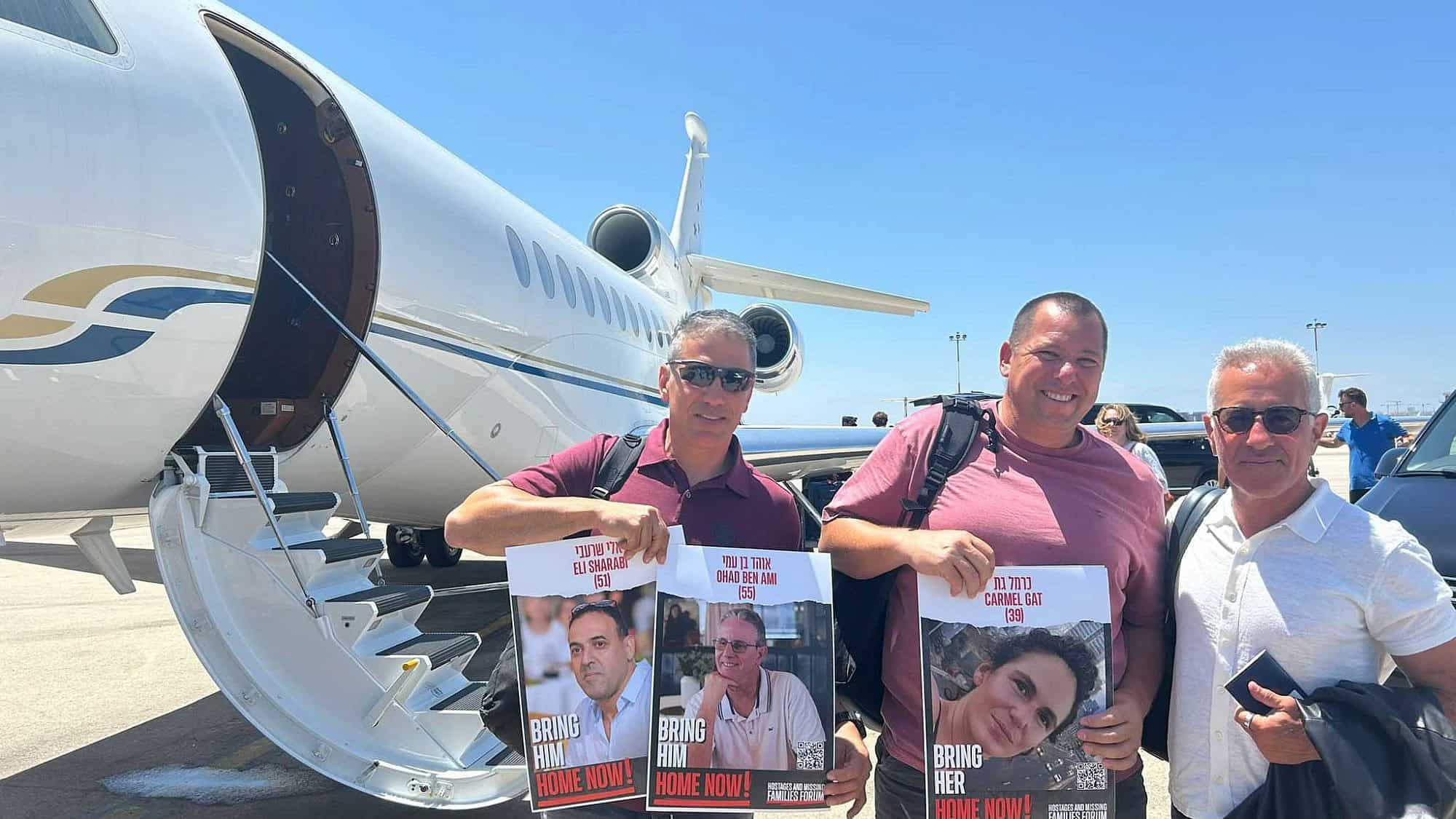 From left: Oct. 7 survivors Sharon Shevo and Avida Bachar and Israel Premier Tech co-owner Sylvan Adams prepare to board a flight to Italy for the Tour de France, at Ben Gurion Airport, June 26, 2024. Photo by Amelie Botbol.