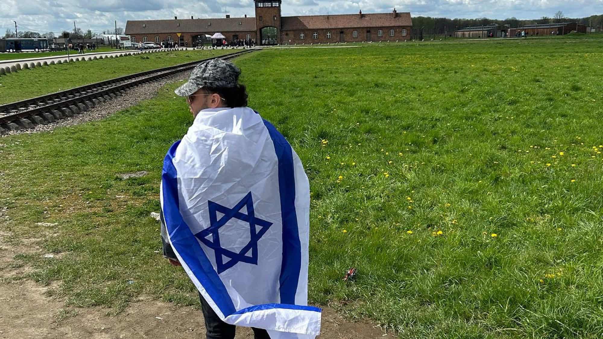 Andrew Weiss, a rising senior at the University of Michigan, at the grounds of Auschwitz on a trip to Poland in April 2024. Credit: Courtesy.