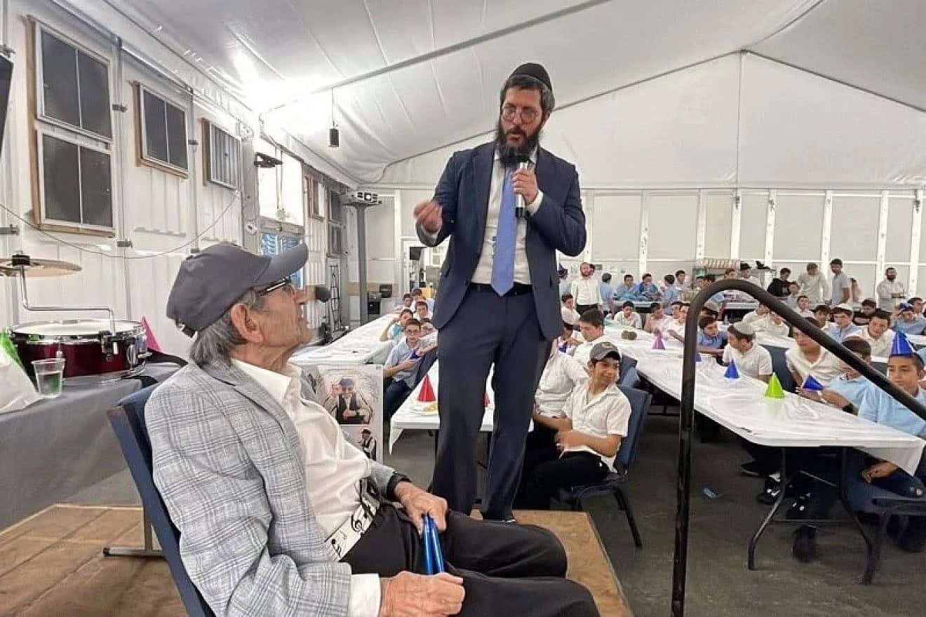 Rabbi Yakov Garfinkel, Lubavitch Educational Center Jewish day school in Miami, addresses the crowd at Holocaust survivor and Florida resident Saul Dreier’s 99th birthday party. Credit: Lubavitch Educational Center Miami via Chabad.org/News.