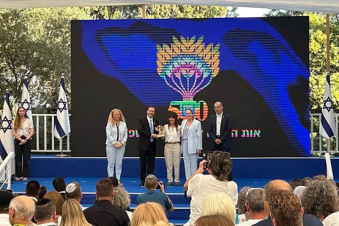 Yahaloma Zechut (center), CEO of the Ofakim Resilience Center, receiving the Presidential Volunteer Medal at the President's Residence in Jerusalem, June 19, 2024. Credit: Courtesy.
