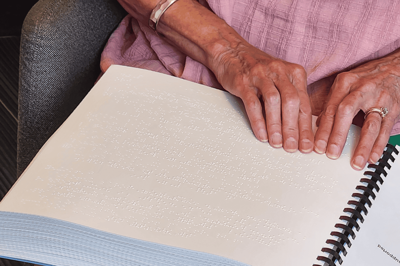 Reading from the new braille edition of “Siddur Lev Shalem for Shabbat and Festivals.” Credit: Courtesy.