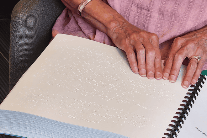 Reading from the new braille edition of “Siddur Lev Shalem for Shabbat and Festivals.” Credit: Courtesy.