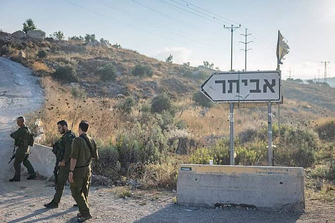 Israeli soldiers stand guard at the newly town of Evyatar in Samaria, July 7, 2024. Photo by Chaim Goldberg/Flash90.