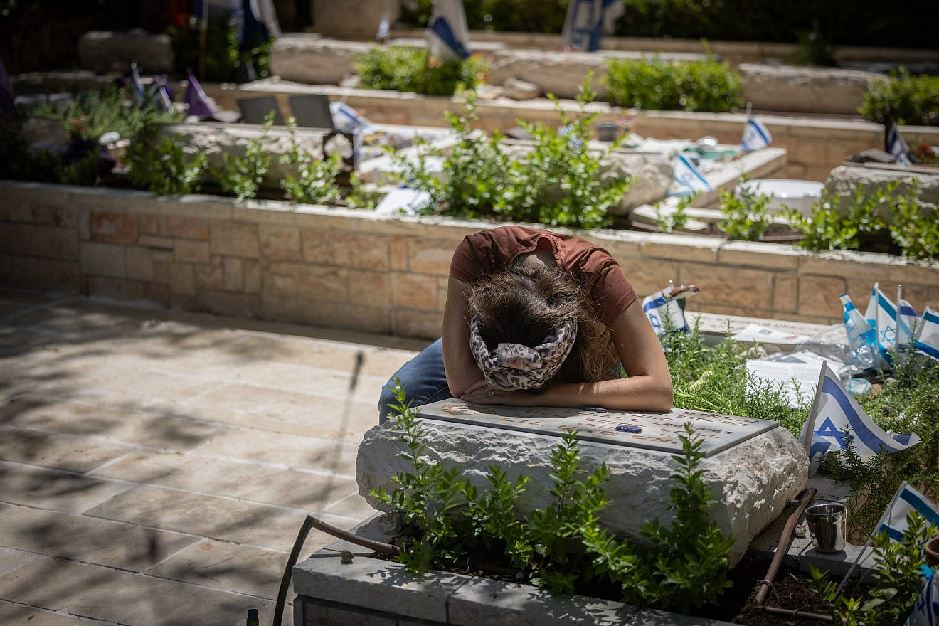 Anat Meir mourns near the grave of her husband, Sayeret Matkal soldier David Meir, who was killed by Hamas terrorists on Oct. 7 at the battle on Kibbutz Be'eri, at Mount Herzl Military Cemetery in Jerusalem on July 9, 2024. Photo by Chaim Goldberg/Flash90.