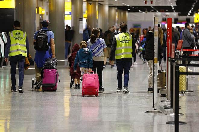 Australian officials help passengers at Heathrow in London as they are repatriated from Israel, Oct. 17, 2023. Photo by Peter Nicholls/Getty Images.