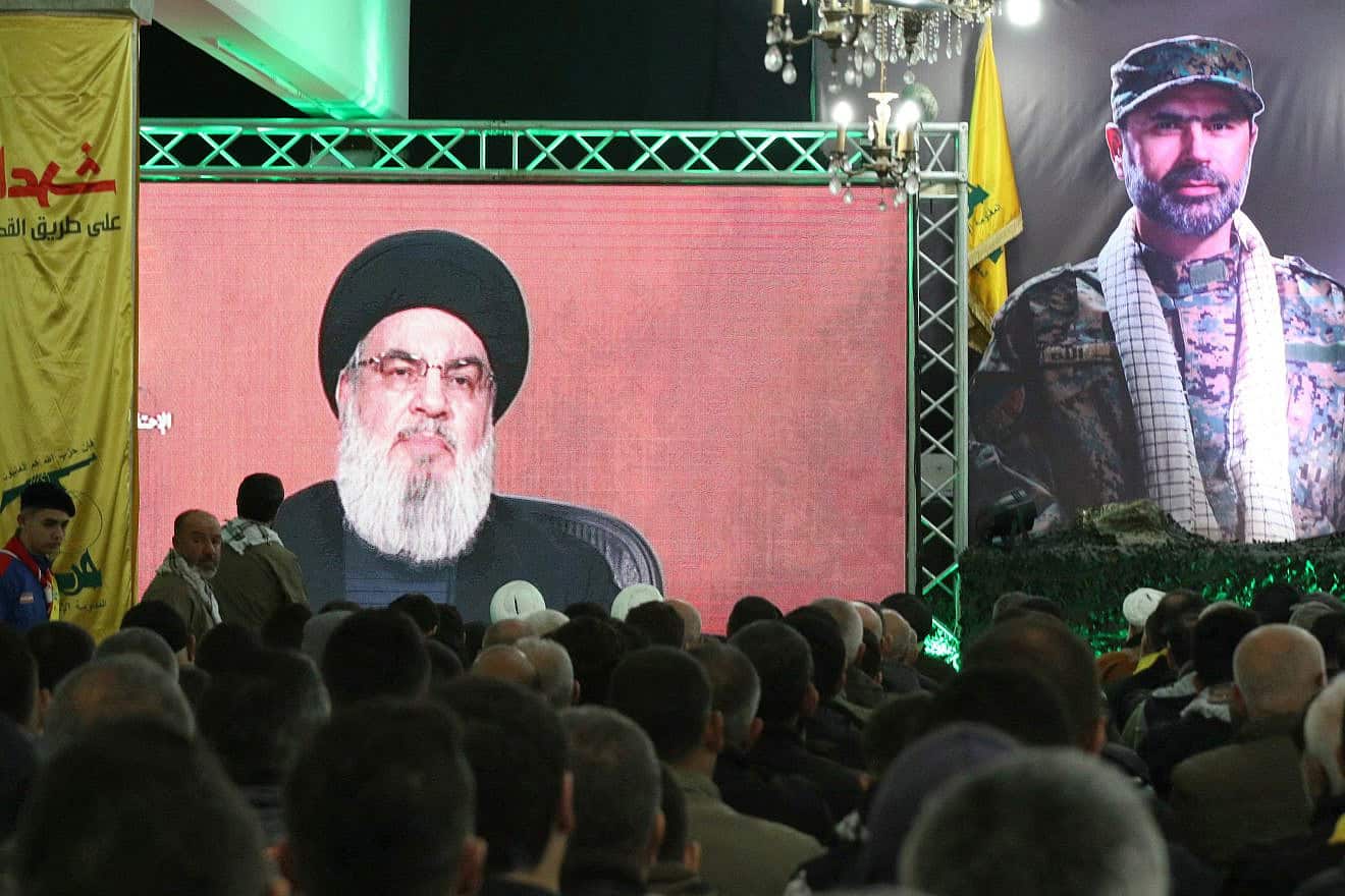Hezbollah leader Hassan Nasrallah delivers a televised speech to mark the one-week anniversary of the killing of top field commander Wissam Tawil (pictured-R), Southern Lebanon, Jan.14, 2024. Photo by Mahmoud Zayyat/AFP via Getty Images.