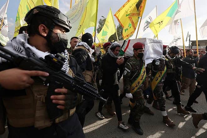 Members of Hashed al-shaabi (Popular Mobilization) forces carry the coffin of a comrade who died in U.S. air strikes targeting Iran-backed groups the day before, during his funeral at the Hashed al-shaabi forces' headquarters in Baghdad on January 25, 2024. Photo by Ahmad al-Rubaye/AFP via Getty Images.