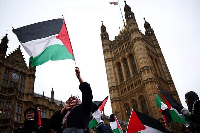 A demonstrator waves Palestinian flag while chanting slogans during a protest in Parliament Square in London on Feb. 21, 2024.Photo by Henry Nicholls/AFP via Getty Images.