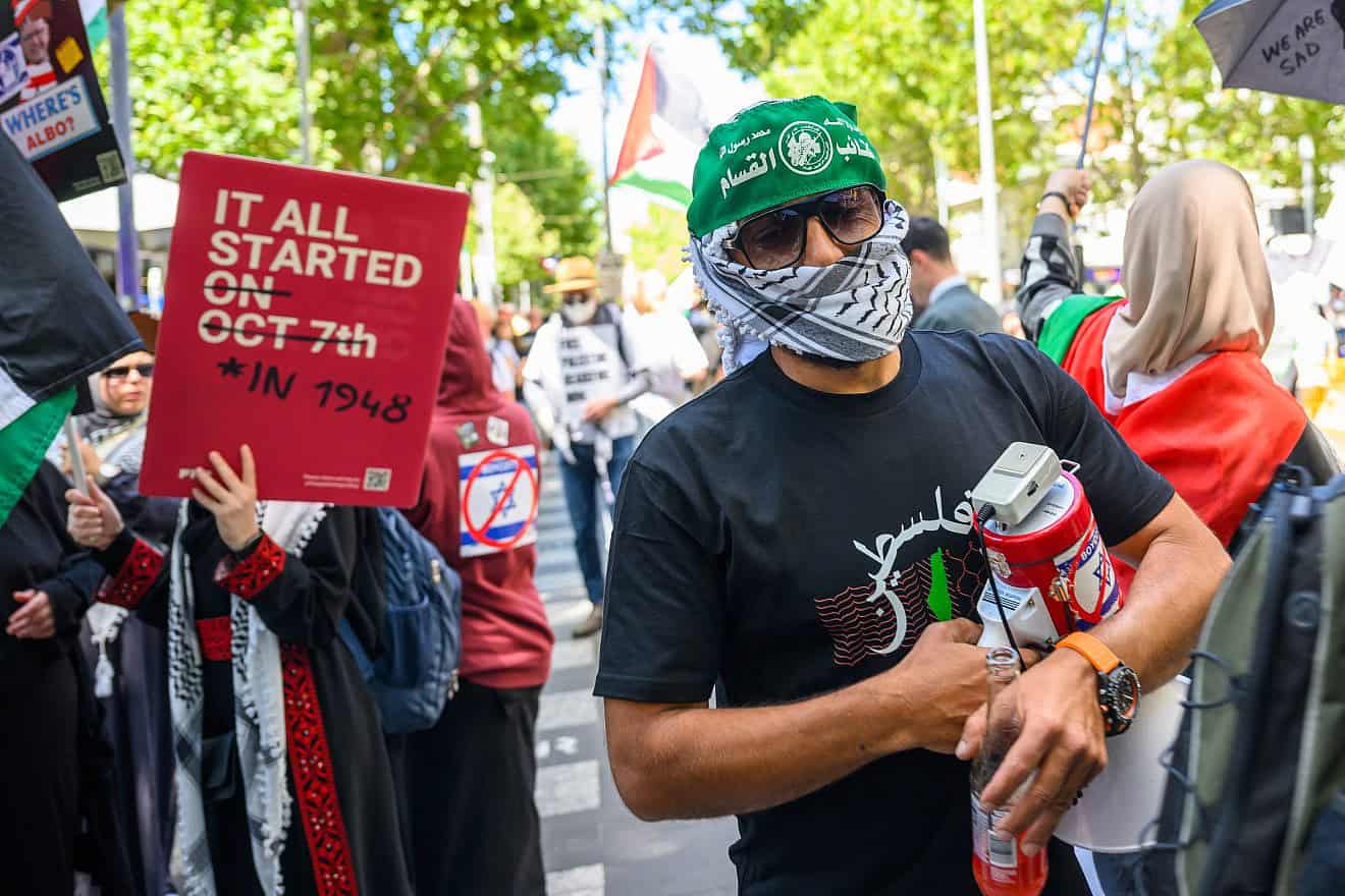 A man wearing the Hamas "military" wing's Al-Qassam Brigade headband demonstrates during the Save Rafah Now and Free Julian Assange Rally outside the Victoria State Library in Melbourne on Feb. 18, 2024. Photo by Alexi Rosenfeld/Getty Images.