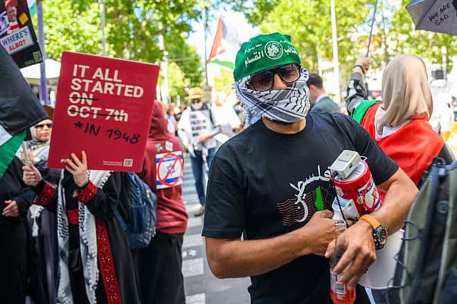 A man wearing the Hamas "military" wing's Al-Qassam Brigade headband demonstrates during the Save Rafah Now and Free Julian Assange Rally outside the Victoria State Library in Melbourne on Feb. 18, 2024. Photo by Alexi Rosenfeld/Getty Images.