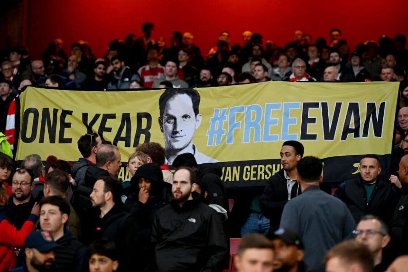 Fans display a banner in  support of Evan Gershkovich, an American journalist imprisoned in Russia, during a Premier League match at Emirates Stadium in London, England on April 3, 2024. Credit: Shaun Botterill / Getty Images.