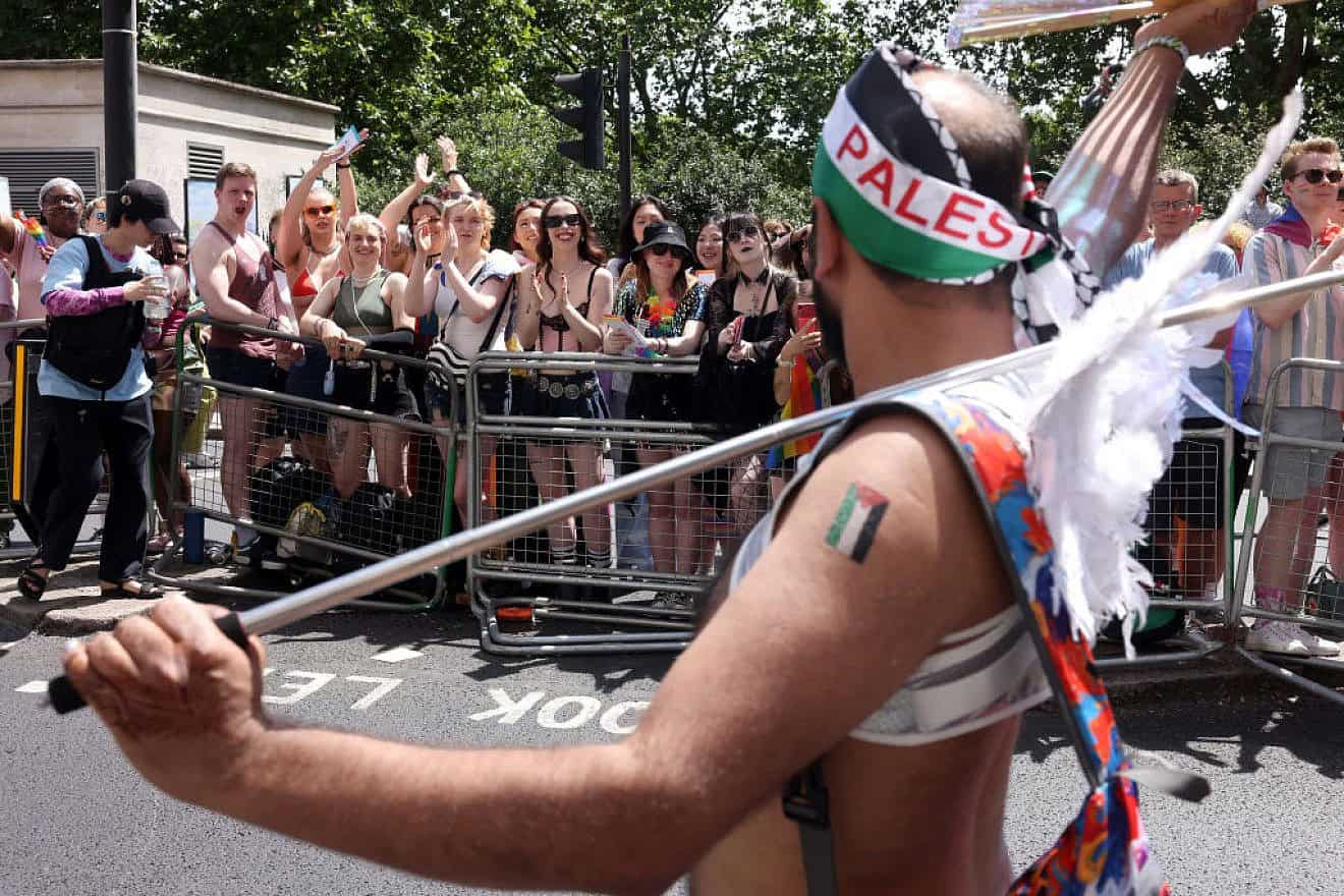 An anti-Israel parade-goer walks past the crowds during Pride In London on June 29, 2024. Credit: Alex McBride/Getty Images.