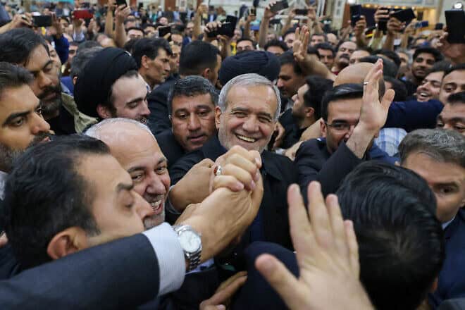 Supporters cheer as newly elected Iranian President Masoud Pezeshkian arrives at the shrine of the Islamic Republic's founder Ayatollah Ruhollah Khomeini in Tehran on July 6, 2024. Credit: Atta Kenare / AFP via Getty Images.