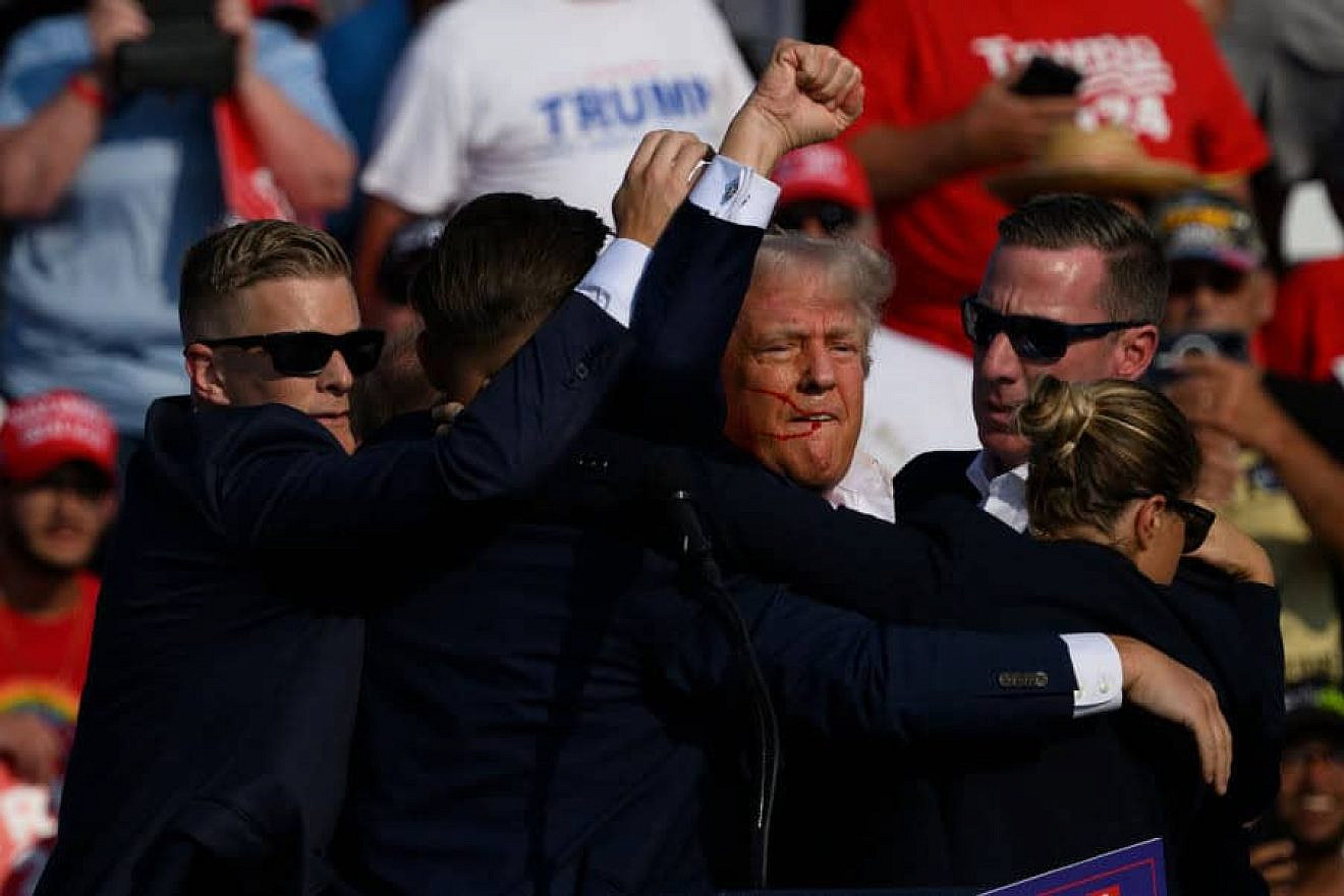 Former U.S. President Donald Trump is whisked away by Secret Service agents after shots rang out at a campaign rally in Butler, Pennsylvania on July 13, 2024.
Credit: Jeff Swensen/Getty Images.