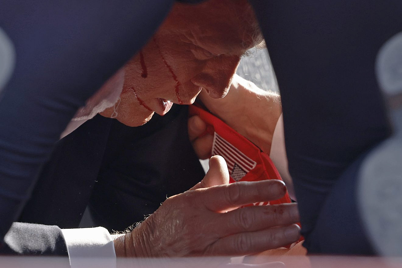Secret Service tend to republican presidential candidate former President Donald Trump onstage at a rally in Butler, Pa., on July 13, 2024. Photo by Anna Moneymaker/Getty Images.